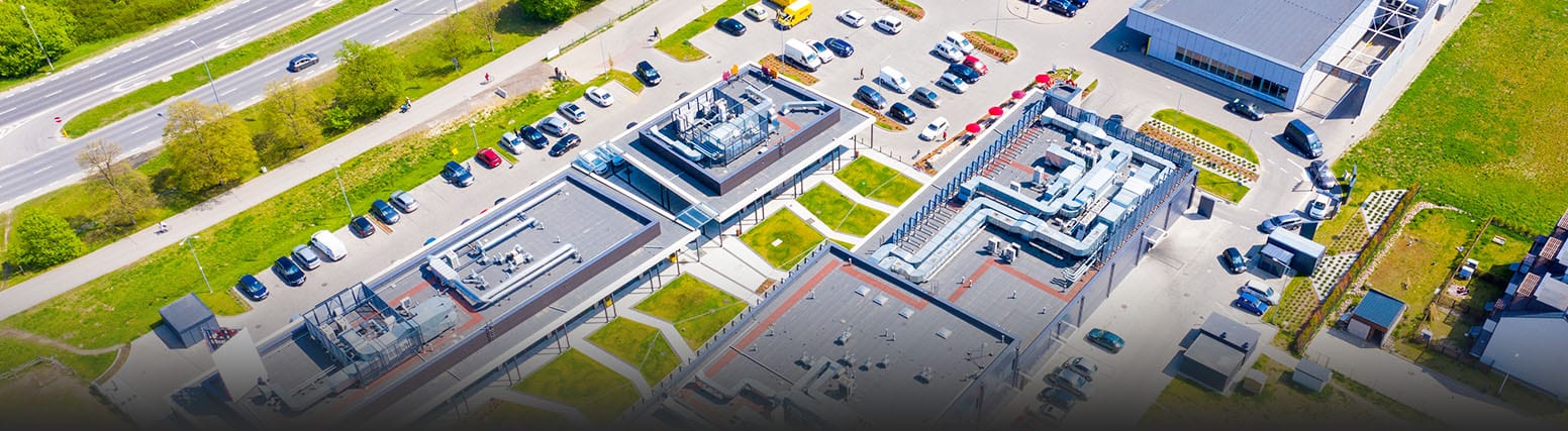 Aerial view of shopping center and parking lot with cars