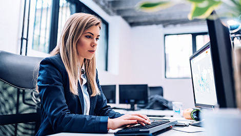 Woman at her desk viewing a digital map