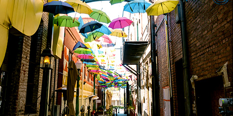 A local street with restaurants covered by suspended umbrellas
