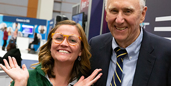 Student posing for a photo with Jack Dangermond