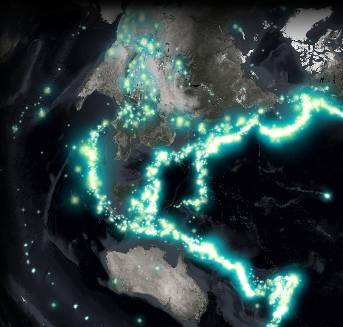 A satellite image of the world in dark grays with areas of concentration brilliantly lit in white and blue