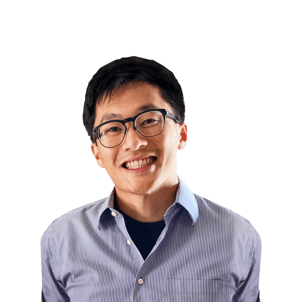 Aote Xin smiling and wearing a pinstriped shirt with a green tree-lined sidewalk in the background