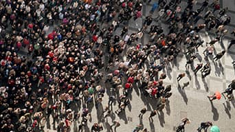 A large crowd of people gathered in the street