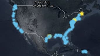 A map of North America in dark gray with glowing sky-blue dots outlining the coastlines