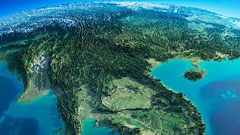 A detailed aerial satellite image of a forested coastal region