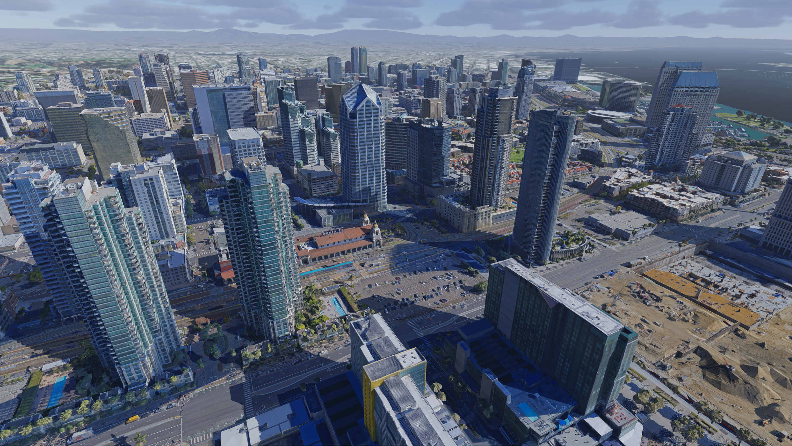 An aerial view of a downtown area with tall skyscrapers and construction in the foreground