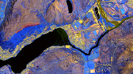 Aerial satellite image of land and water with areas and routes highlighted in yellow