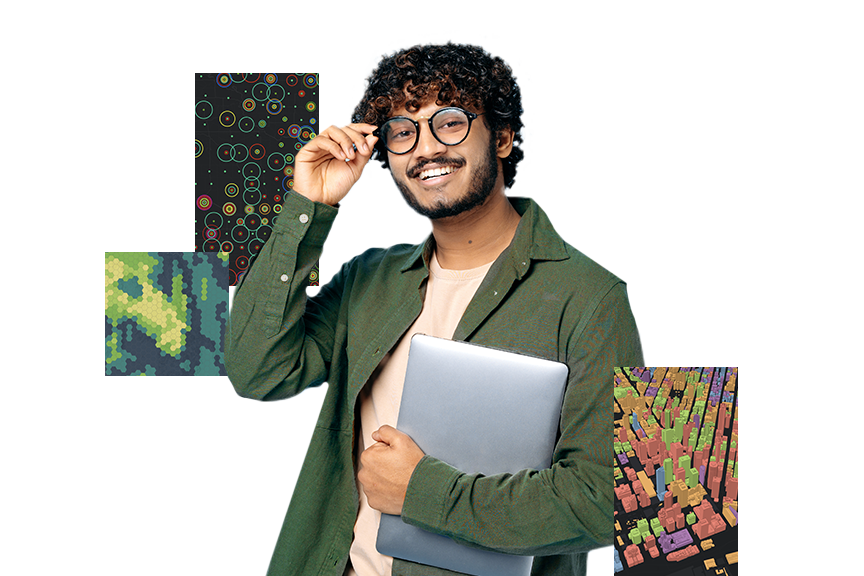 A young man wearing glasses and a green shirt holding a silver laptop