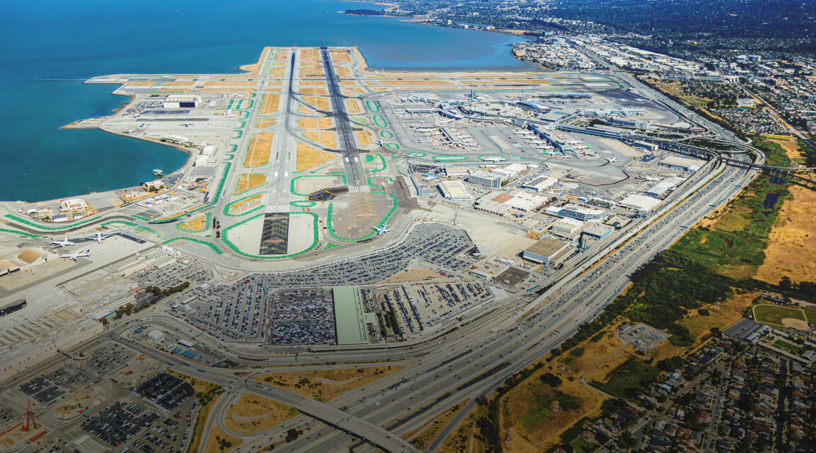 An airport runway located next to a body of water