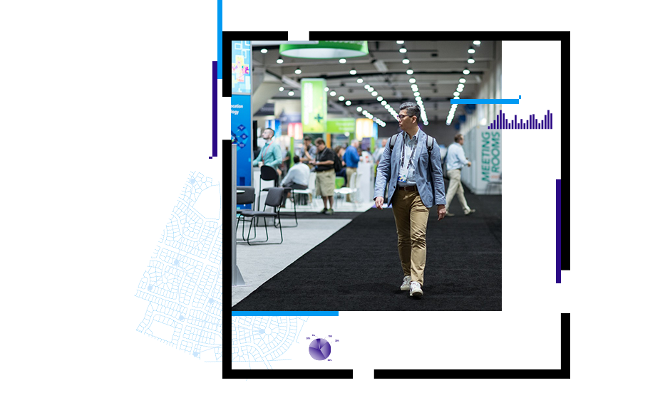 Person walking by expo area at a conference and another attendee holding up a card