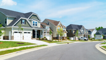 A clean bright street lined with upscale tract houses