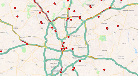 A map with highways highlighted in blue with red dots dispersed throughout overlaid with a play button