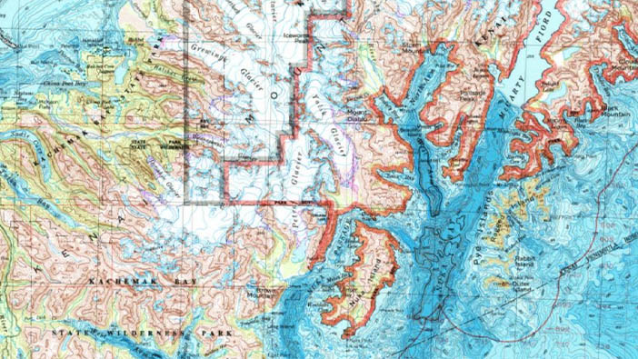 A classic map of Seward, Alaska in pink and green with aqua blue waters