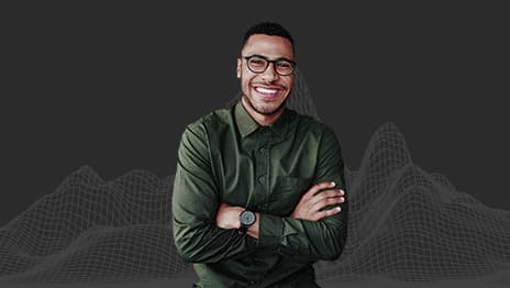 A smiling person wearing glasses and a green collared shirt with their arms crossed overlaid on a wireframe of a mountain range