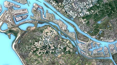 A satellite view of densely developed land near a body of water